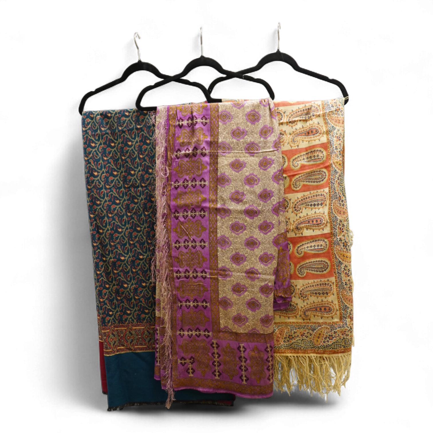 A 19th century printed silk shawl and a printed paisley shawl, together with a late 20th century wool machine woven stole with Oswal label. Condition - the two 19th century shawls are damaged but useful for TV and film c